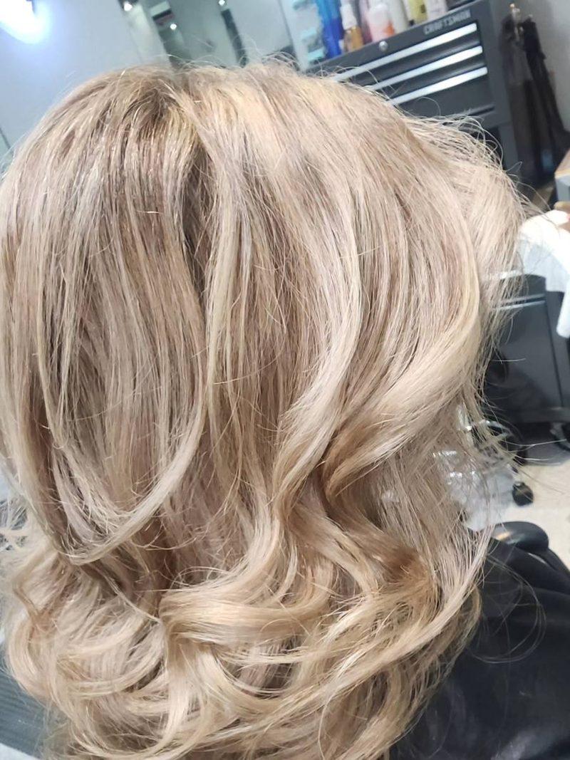 Icy blonde balayage with soft curls