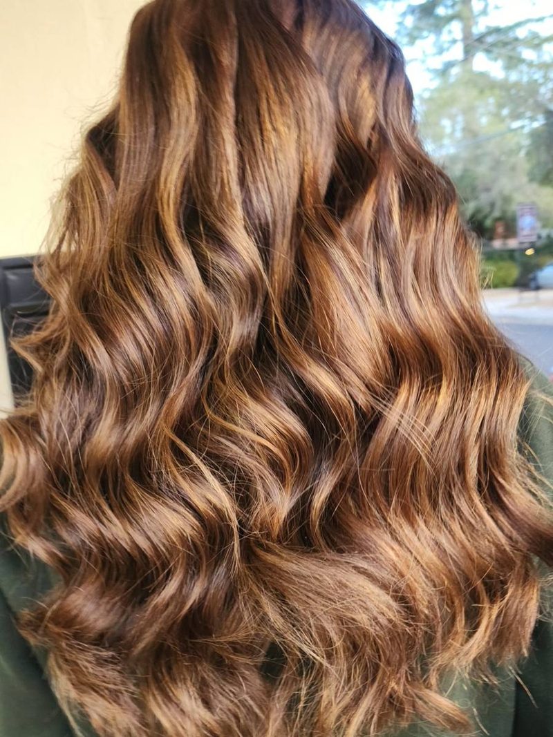 Golden caramel highlights on long curls